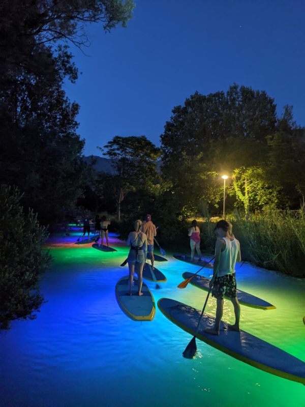 Illuminated sunset paddleboarding experience